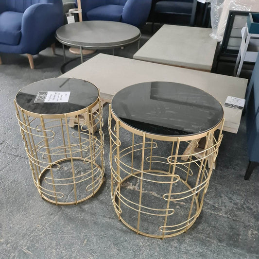 Set Of 2 Side Tables Made from metal. Gold finish, with black glass tops.