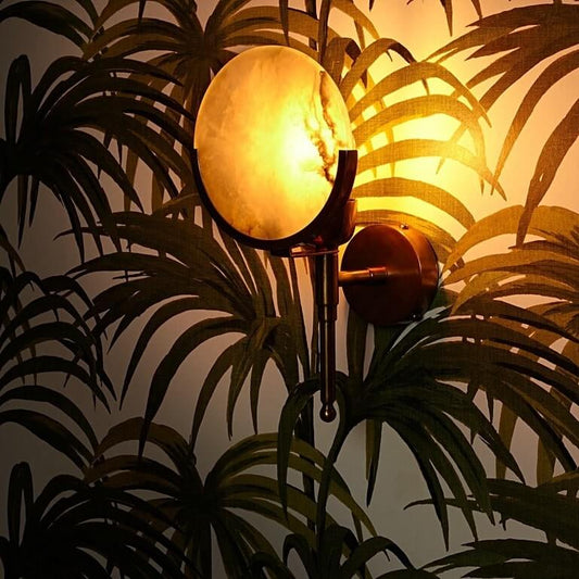 Firefly wall light in antique brass with an alabaster globe, 30cm